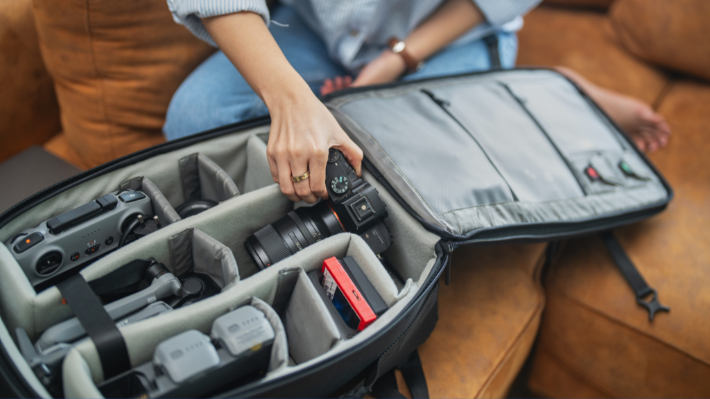 Traveler packing electronics and other valuables for a trip