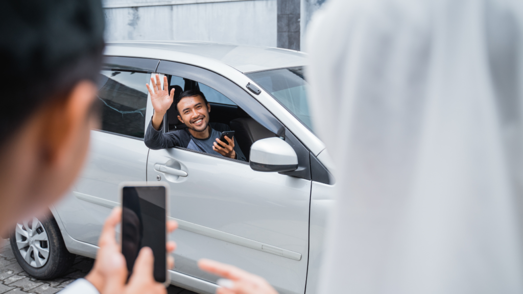 Driver greeting passengers arriving for a car pickup