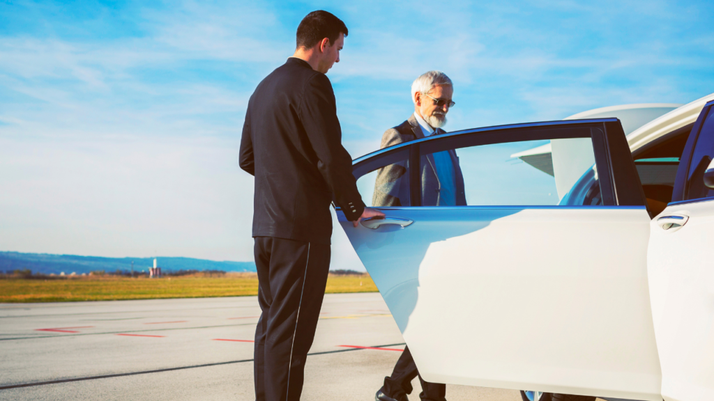 Private driver opening a car door for a traveler at the airport