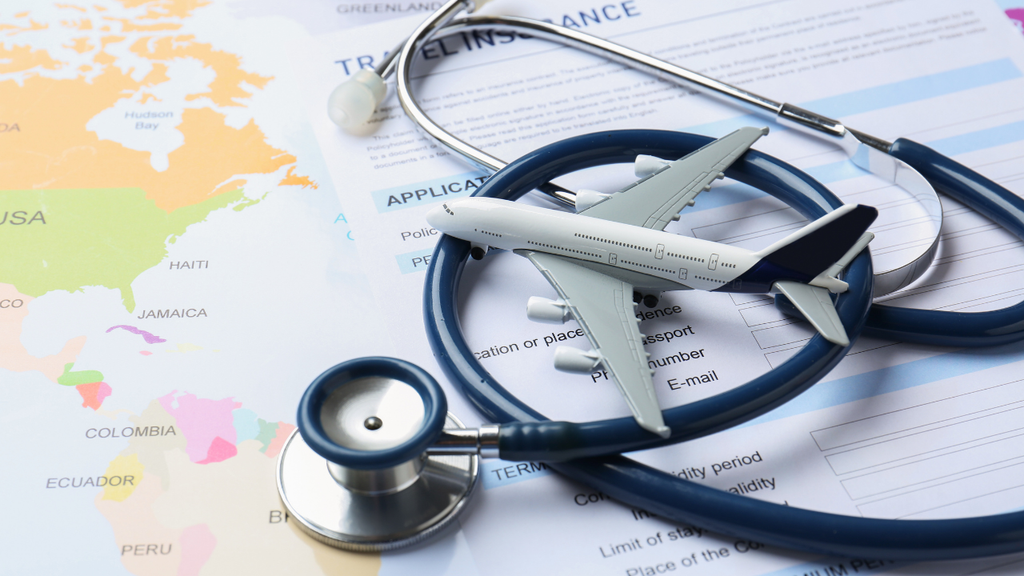 Airplane model and stethoscope on a travel insurance application